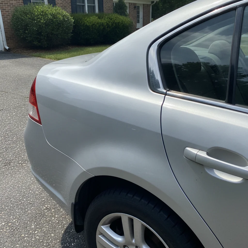Subtle paint color mismatch on a used car rear quarter panel indicating prior bodywork repair